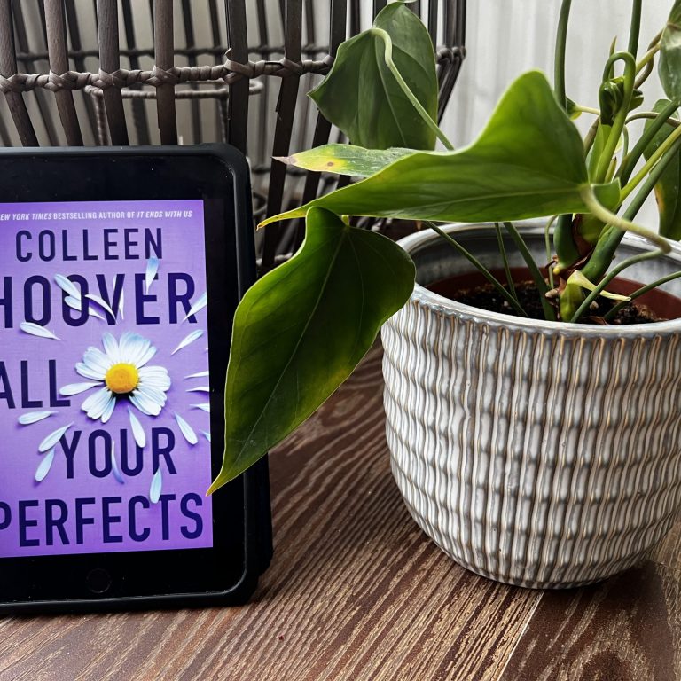 colleen hoover book and a plant
